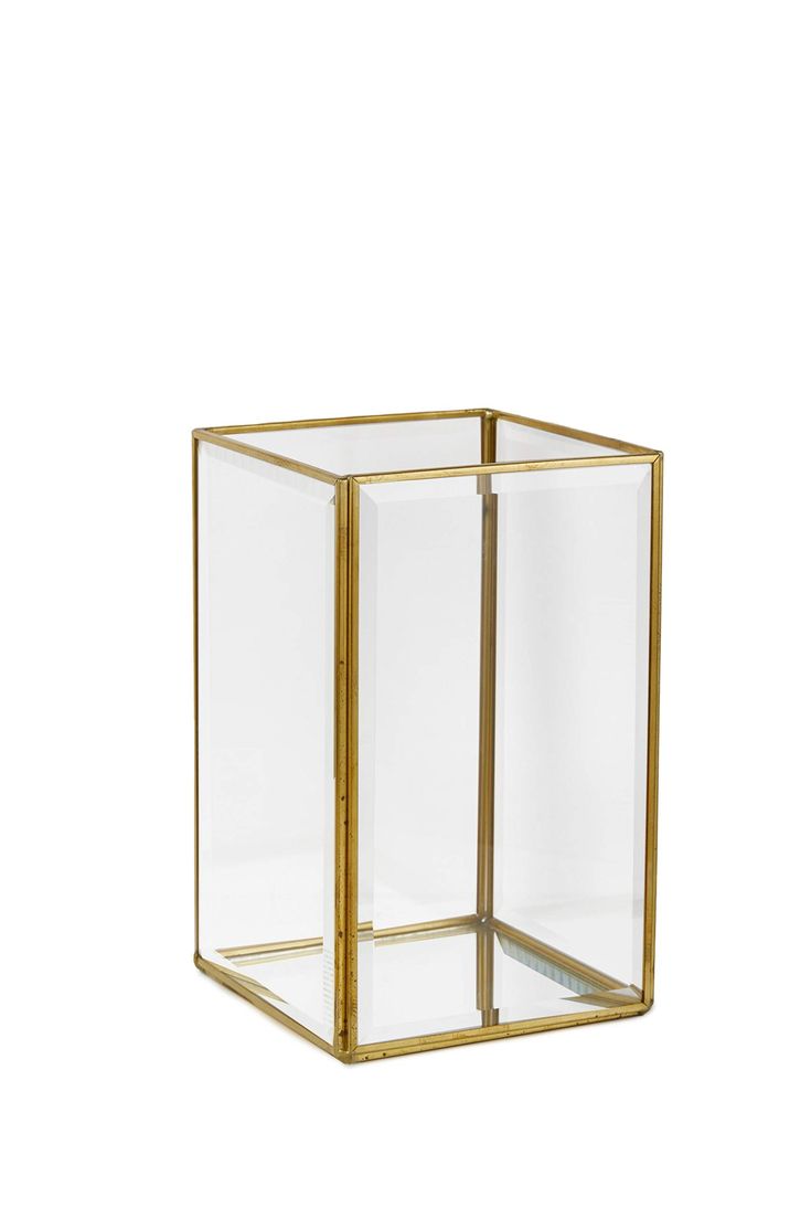 a glass box with gold trimming on the bottom and sides, sitting in front of a white background