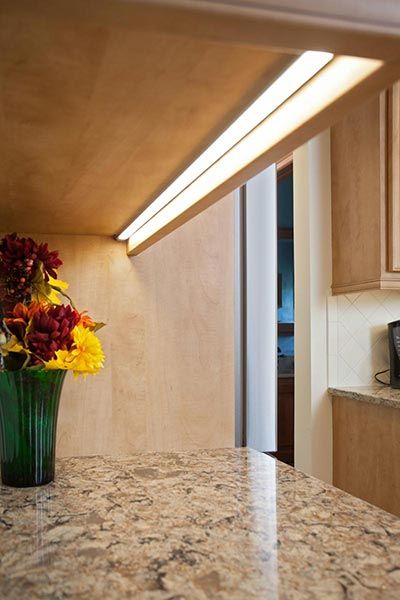 a vase filled with flowers sitting on top of a counter