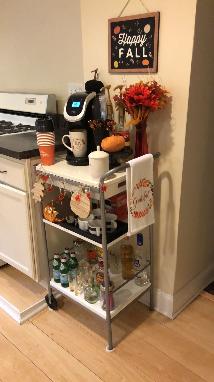 a kitchen area with a coffee maker and various items on the shelf next to the stove