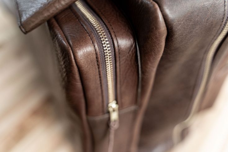 Fly in style next time you take a business trip or vacation with our limited edition brown Leather Flight Bag. This leather bag is finely handcrafted from the highest quality American Bison hides and 100% Made in USA. Any artisan that plays a part in handcrafting your flight bag adds their initials inside, making each flight bag unique. Each handmade vintage leather flight bag fits perfectly in an overhead compartment of an airplane so you can travel quick and easy with this carry on bag. Not on Travel Backpack With Smooth Grain In Brown, Brown Travel Backpack With Smooth Grain, Formal Brown Travel Bag With Leather Lining, Brown Rectangular Leather Backpack For Formal Occasions, Brown Leather Backpack For Business Trips, Brown Leather Backpack With Leather Handles For Everyday, Brown Vegetable Tanned Leather Backpack For Travel, Brown Backpack For Business Trips, Brown Vegetable Tanned Leather Backpack With Leather Lining