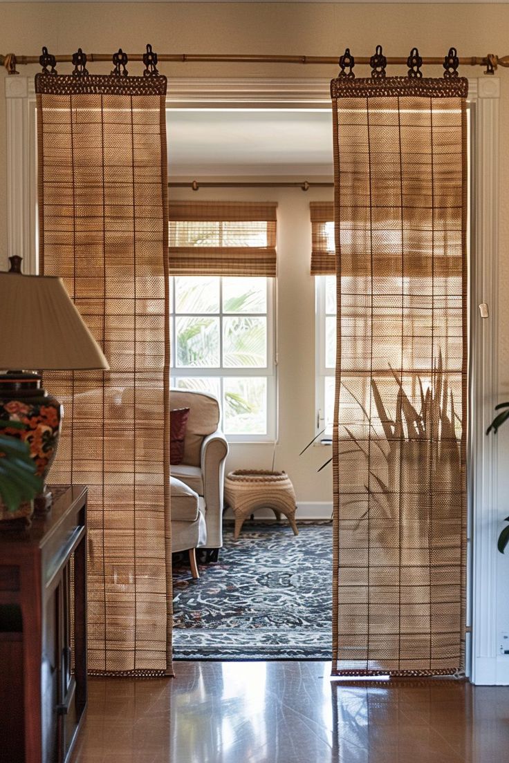 an open living room door with bamboo blinds on the windowsill and chairs in the background