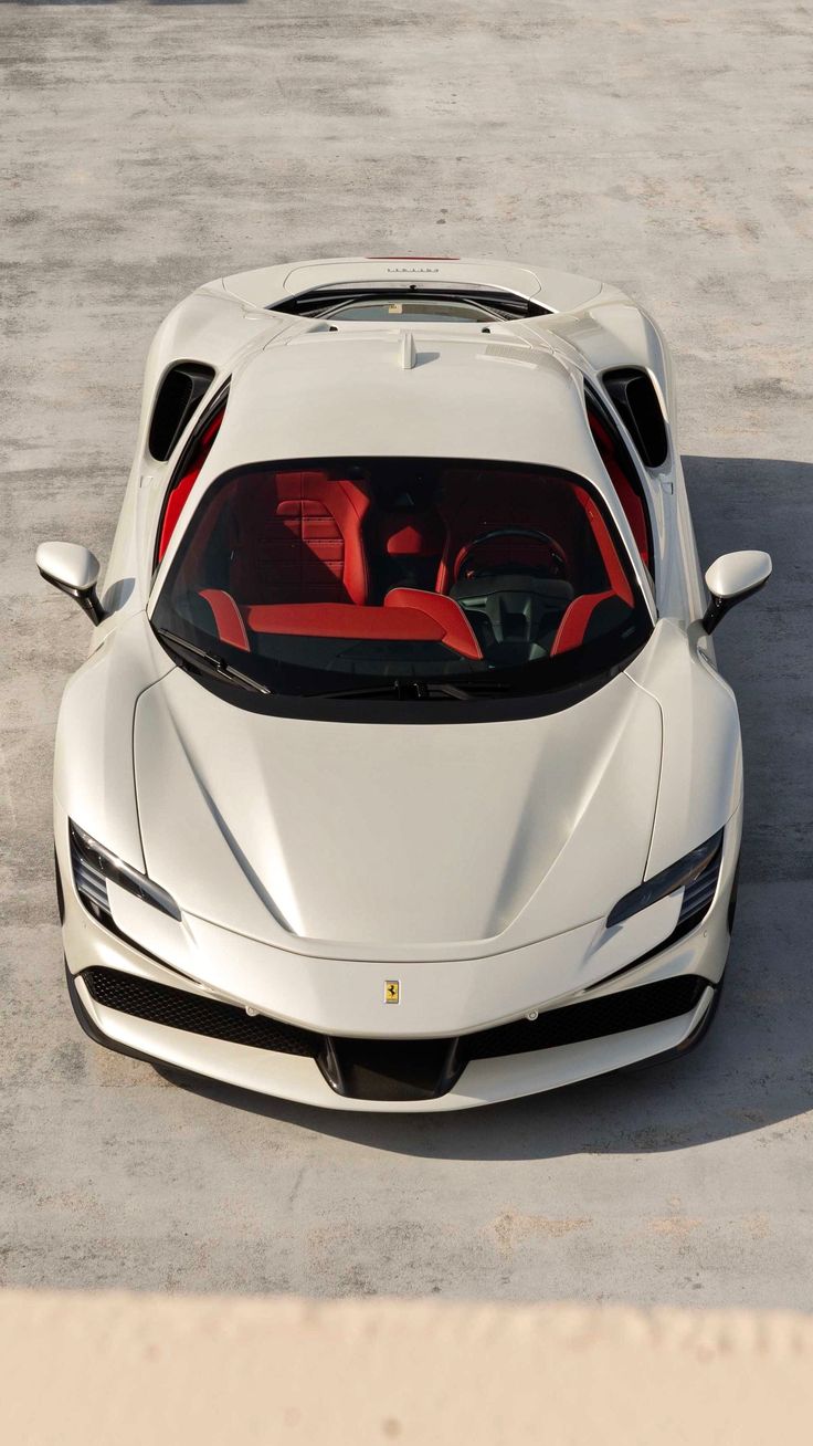 a white sports car parked in a parking lot