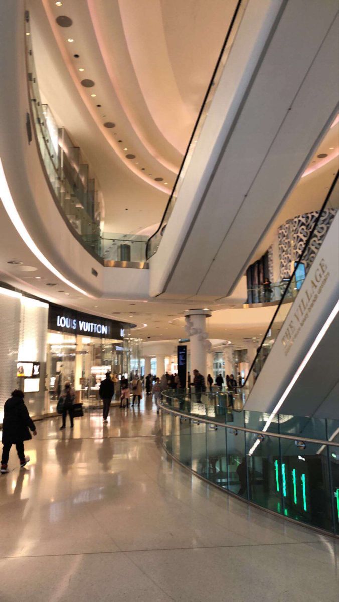 people are walking through an airport lobby