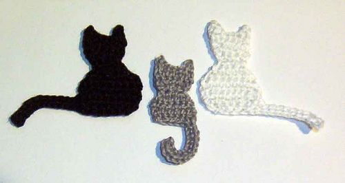 three cat silhouettes are shown on the wall next to each other, one black and one white