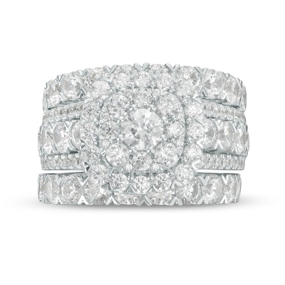 Display your love for all to see with the eye-catching sparkle of this 5 ct. t.w. diamond three-piece bridal set in white gold. Fashioned in 14K white gold The engagement ring showcases a 1/3 ct. round center diamond sparkling in two cushion-shaped frames of diamonds. Rows of 1/8 ct. diamonds glisten between borders of smaller diamonds along the triple-row shank. Dazzling 1/8 and 1/10 ct. diamonds line the two coordinating wedding bands to complete this exceptional ensemble. This bridal set cele Round Cut Diamond Bridal Set With Accents, Dazzling Bridal Sets With Brilliant Cut Diamonds, Dazzling Diamond Bridal Set With Center Stone, Diamond White Brilliant Cut Bridal Sets In Fine Jewelry, Diamond White Brilliant Cut Bridal Sets, Brilliant Cut Moissanite Bridal Set In Diamond White, Dazzling Diamond White Bridal Sets With Prong Setting, Dazzling Moissanite Bridal Sets With Brilliant Cut, White Diamond Bridal Set With Brilliant Cut