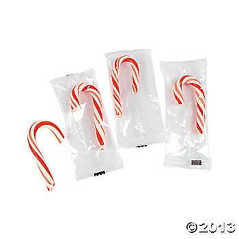 three candy canes in plastic bags on a white background