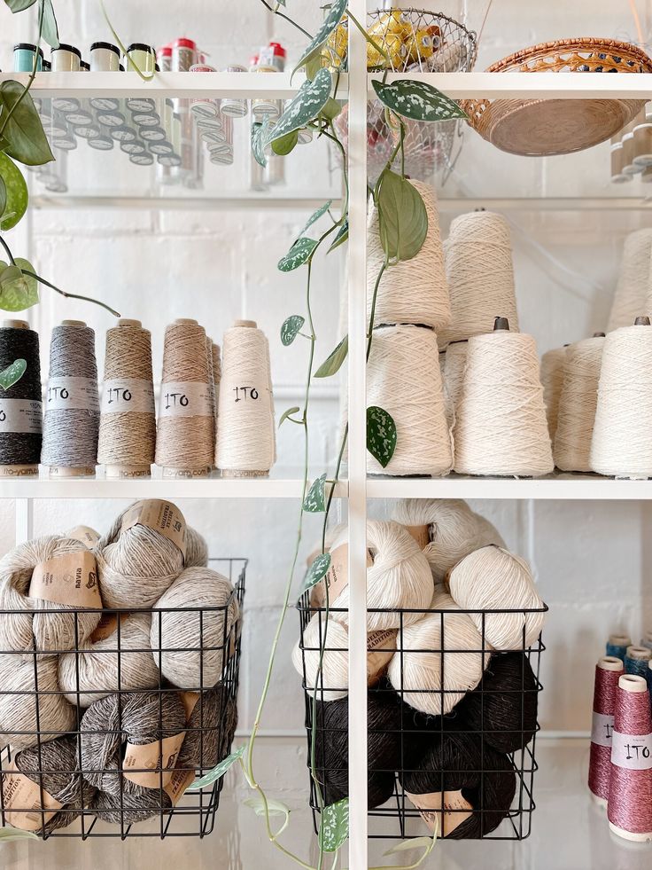 the shelves are filled with different types of yarn