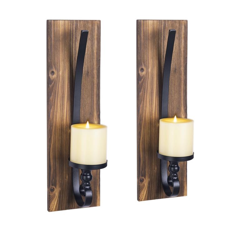 two candle holders are shown on the wall