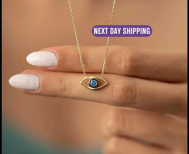 🧿 The Magic of Personalized Protection   Seeking the perfect birthday gift for her or a meaningful personalized gift for mom? Dive into the enchantment of the Evil Eye Necklace. This beautifully crafted eye-shaped pendant with its captivating blue stone at the center is not merely an accessory. It's a beacon of protection, carrying centuries of traditions. Bridging the gap between ancient lore and contemporary elegance, it offers a piece rich in history and modern style -- an ideal choice for those who value sentiment in every jewel they wear. 🚀 Swift & Safe Deliveries   Reliable and prompt, our shipping services through UPS & Royal Mail ensure your piece arrives straight from the heart of the UK without a hitch. 🔙 Your Peace of Mind Guaranteed   We understand the hesitations of online Blue Jewelry For May Birthstone Gift, Blue May Birthstone Jewelry For Gift, Blue Jewelry Gift For May Birthstone, Spiritual 14k Gold Jewelry For Gifts, Blue Jewelry Gift, Spiritual Jewelry As Mother's Day Gift, Blue Jewelry For Mother's Day Gift, Blue Jewelry Gift For Mother's Day, Blue Jewelry For Birthday Gift And Mother's Day