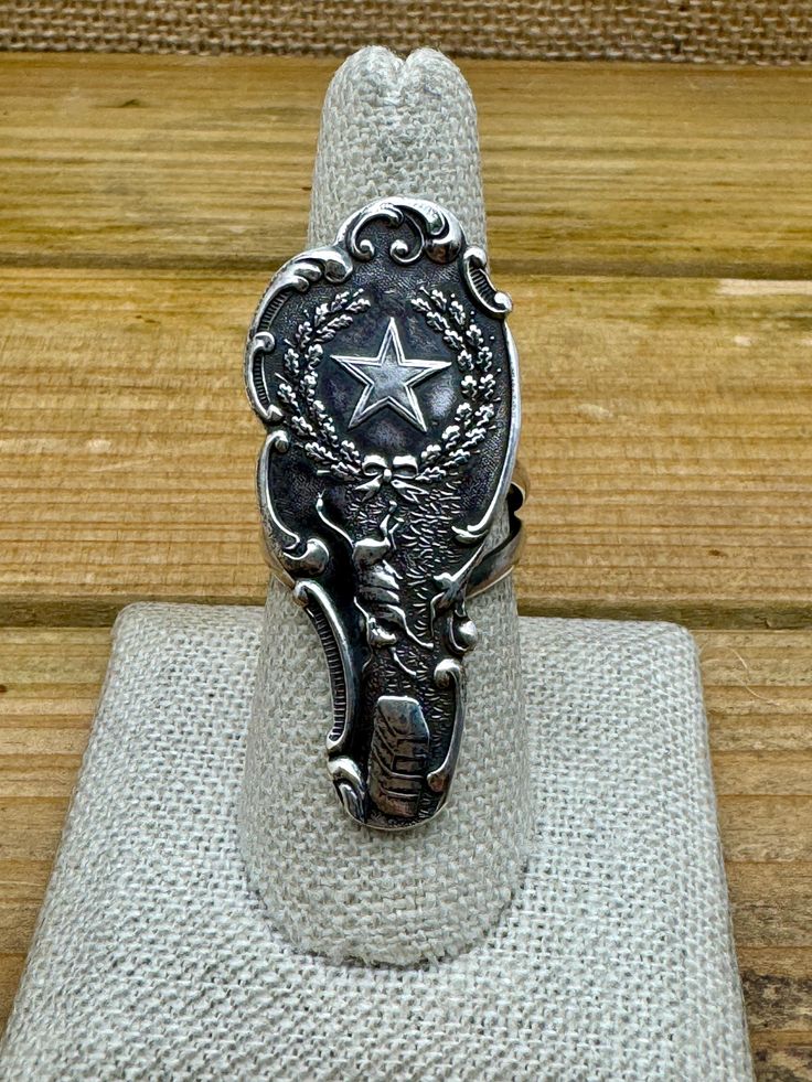 Add this vintage sterling silver Texas collector's souvenir spoon ring to your jewelry collection. This ring is a perfect fit for those who appreciate vintage jewelry. The face of the ring measures 1 3/4" tall by 3/4" wide. The ring weighs 10.8g and is a size 8. We can size most rings for an additional fee, please message me with what size you need and I will get back to you with what price you need. The split double shank measures 5mm thick. There is no artist's hallmark on the ring but it is s Vintage Sterling Silver Engraved Stamped Ring, Antique Silver Engraved Vintage Rings, Vintage Engraved Silver Ring, Vintage Sterling Silver Engraved Ring With Stamped Details, Vintage Antique Silver Engraved Ring Stamped 925, Vintage Stamped Engraved Ring, Vintage Engraved Sterling Silver Ring In Antique Silver, Vintage Silver Engraved Ring, Antique Engraved Silver Ring