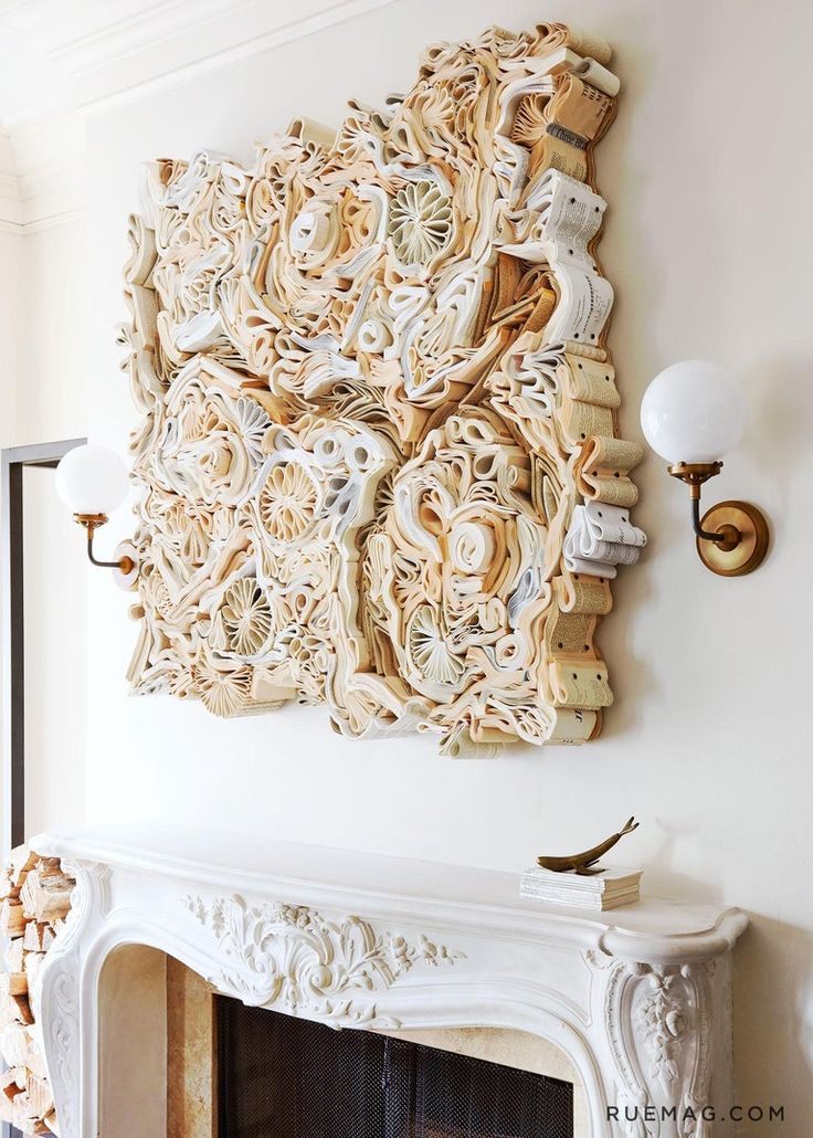 a white fireplace with ornate carvings on the mantle