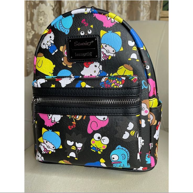 New! Loungefly Hello Kitty Sanrio Rainbow All Over Print Mini Backpack Material: Faux Leather Measurements: W 9" X H 10.5" X D 4.5" Wipe Clean Imported Black Kawaii Backpack For Everyday Use, Playful Black Backpack For Everyday Use, Cute Leather Backpack, Playful Black Bag For Everyday Use, Fun Black Shoulder Bag For Travel, Playful Black Bags For Everyday Use, Fun Black Bags For Back To School, Cute Black Leather Bag, Fun Black Travel Bag