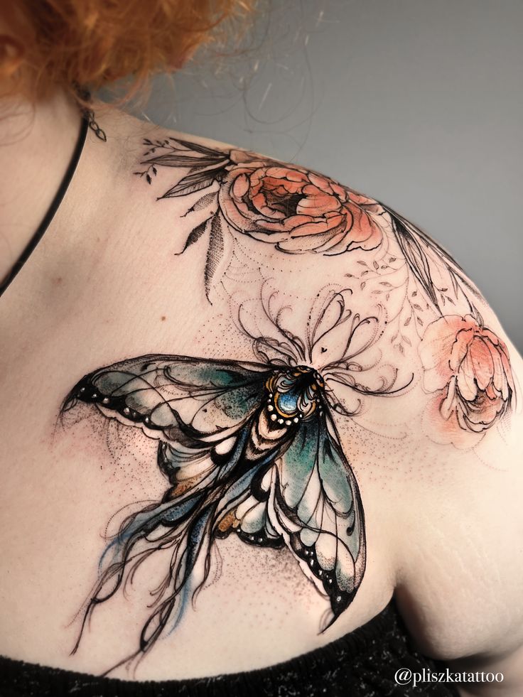 a woman's chest with a butterfly and flowers on it