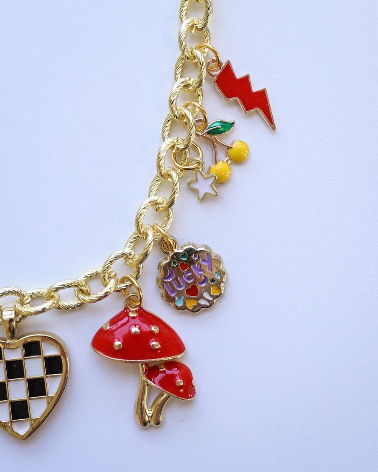 Add a splash of sunshine to your style with our Bright Summer-Themed Gold Plated Charm Necklace. This fun and vibrant accessory features an array of playful summer charms, perfect for capturing the season's essence. Measuring 17 inches in length, it's the ideal piece to brighten up any summer outfit. Crafted with high-quality gold plating, this necklace is designed to bring a touch of joy and color to your wardrobe. Playful Charm Necklace With Dangling Charms For Gift, Playful Dangle Charms Necklace, Playful Dangle Necklaces With Charms, Fun Multicolor Charm Jewelry, Playful Dangle Charm Necklace, Playful Multicolor Jewelry With Removable Charms, Trendy Dangle Charm Necklaces With Removable Charms, Trendy Necklaces With Removable Dangle Charms, Trendy Multicolor Jewelry With Removable Charms