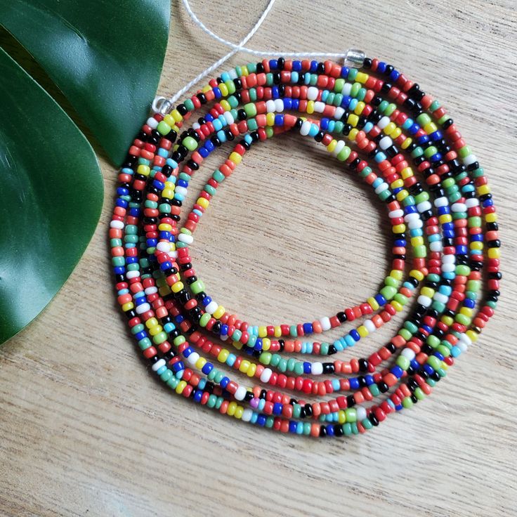 This colorful waistbead was made with multicolored glass seed beads.Waistbead length: 50 inches Strung on strong, cotton cord with 2 clear anchor beads (for adjustment) and 2 knots. Tie on, permanent waistbeads. Waist beads have been worn for centuries in African tradition, and the uses are endless. From adornment and weight management, all the way to signs of maturity and femininity, the diversity of waist beads make them appealing pieces of jewelry to own. They are generally worn under a garme Bohemian Multicolor Letter Beads, Multicolor Waist Beads With Large Beads For Festival, Multicolor Large Beaded Waist Beads For Festival, Colorful Oval Beads Bracelets For Beach, Colorful Oval Beads Bracelet For Beach, Bohemian Heishi Beaded Waist Beads, Multicolor Large Beaded Waist Jewelry For Festival, Colorful Oval Beaded Bracelets For Beach, Colorful Letter Beads For Festival