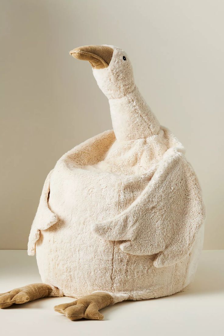 a stuffed duck sitting on top of a white surface