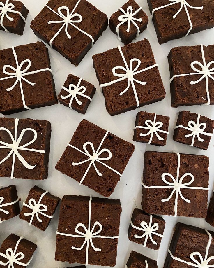 chocolate brownies with white icing and bows on them