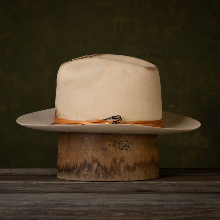 The Wazee is the latest style in our NINE7O Collection. The Wazee is a hat made for uptown, downtown, ranch life, and everything in between. This new take on a classic fedora with some distressing and leather detail is sure to become your go-to hat! The Wazee Details: Buckskin Fashion Weight 6" Tapered Crown 3" Brim Width Keenland Crown Shape Soft Snap Brim Flex Fit Sweatband Mild Distressing Tandy Leather cording with a safety pin accent No Liner Note: This is a Unisex style. If you are not sur Fitted Panama Hat For Western-themed Events, Vintage Fedora With Flat Crown, Fitted Western Style Panama Hat For Western-themed Events, Fitted Western-style Panama Hat For Western-themed Events, Kentucky Derby Top Hat For Ranch With Flat Crown, Kentucky Derby Top Hat With Flat Crown For Ranch, Flat Crown Top Hat For Kentucky Derby, Country Style Fedora For Kentucky Derby With Flat Crown, Fitted Panama Hat For Rodeo With Flat Crown