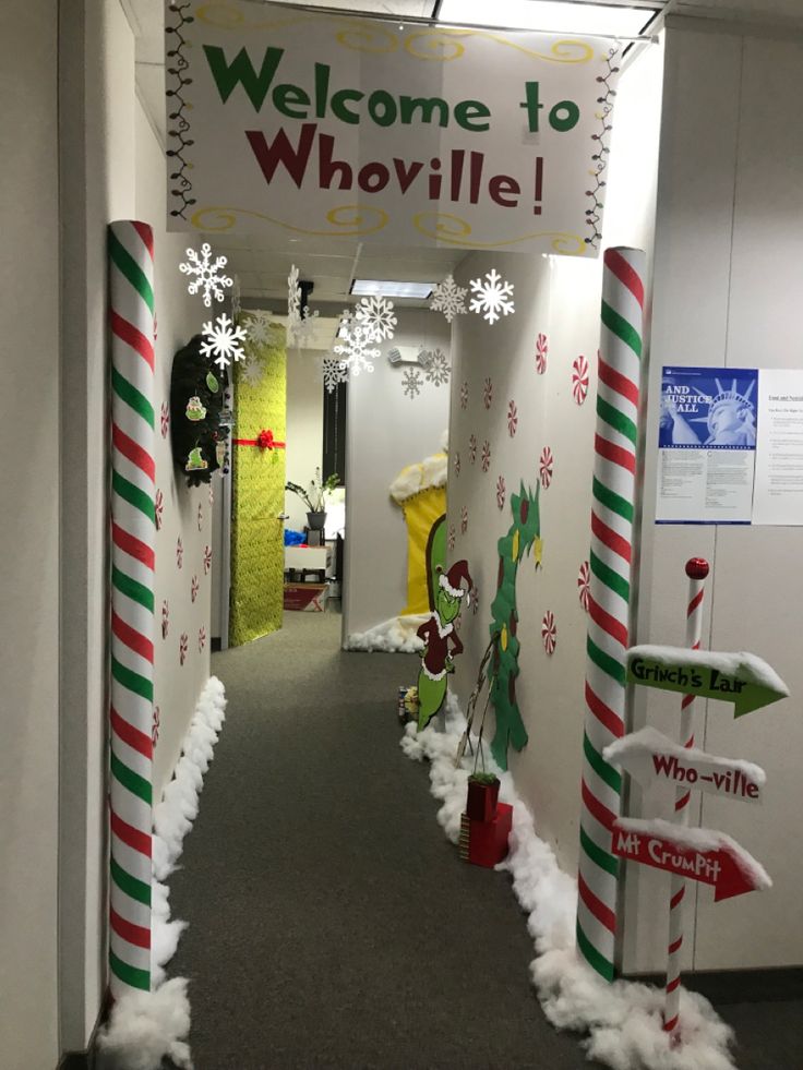 an office hallway decorated for christmas with snowmen and candy canes on the floor