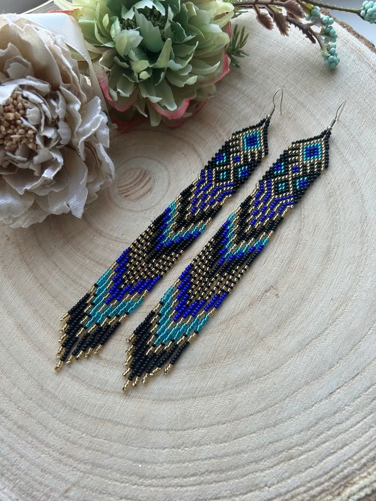 These long dangling earrings made of blue beads with gold accents and fringe perfectly combine sophistication and style. Made from Czech beads. Length 7.2 inches (18cm) Width 0.8 inches (2 cm) Hypoallergenic clasp If you want these earrings in a different color, write to me and I will be happy to make them for you. Elegant Blue Beaded Fringe Earrings, Blue Beaded Fringe Tassel Earrings As Gift, Blue Fringe Beaded Drop Earrings, Blue Fringed Beaded Drop Earrings, Elegant Blue Tassel Earrings With Beaded Fringe, Blue Long Drop Jewelry With Beaded Fringe, Blue Beaded Fringe Dangle Jewelry, Blue Tassel Earrings With Round Beads, Blue Fringe Dangle Chandelier Earrings