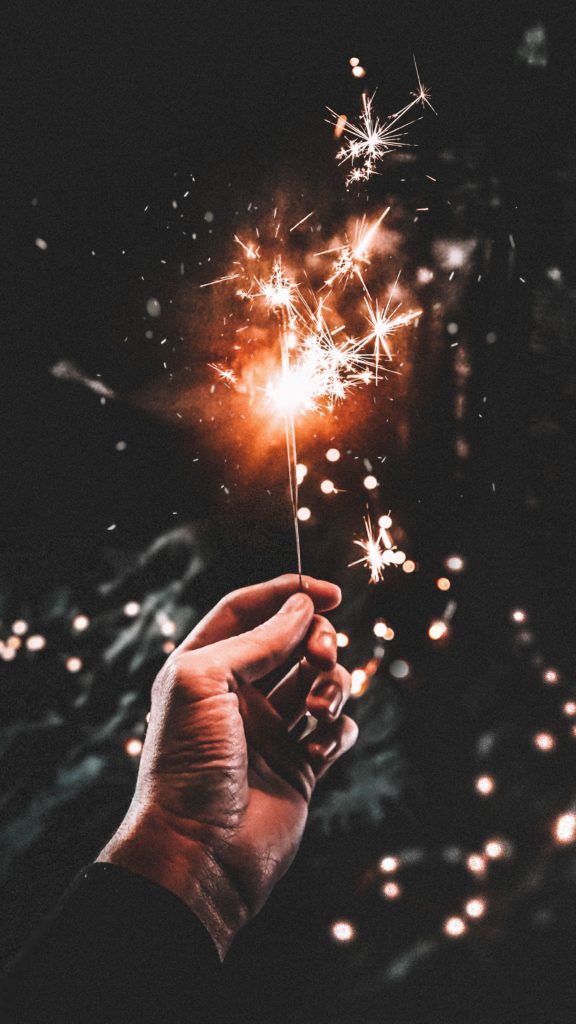 a person holding a sparkler in their hand