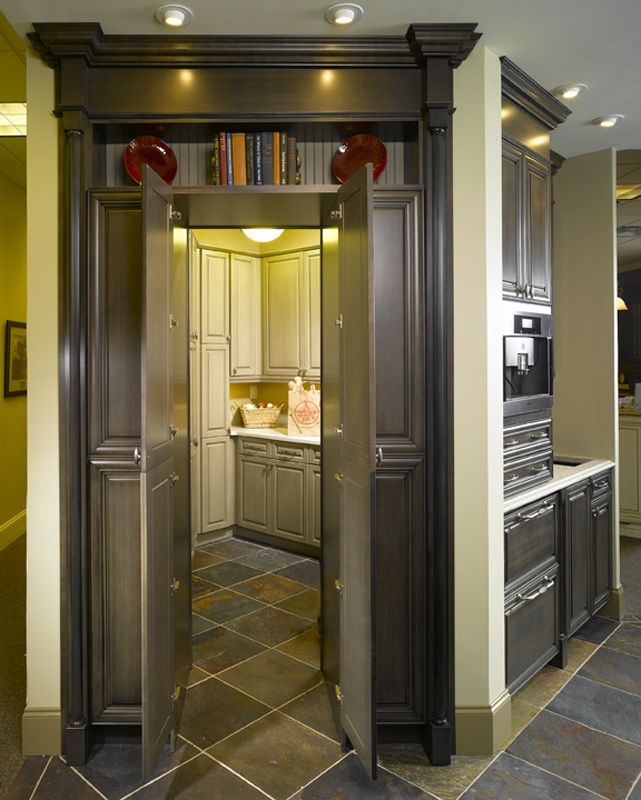 an open door leading into a kitchen with lots of counter space and cabinets in it