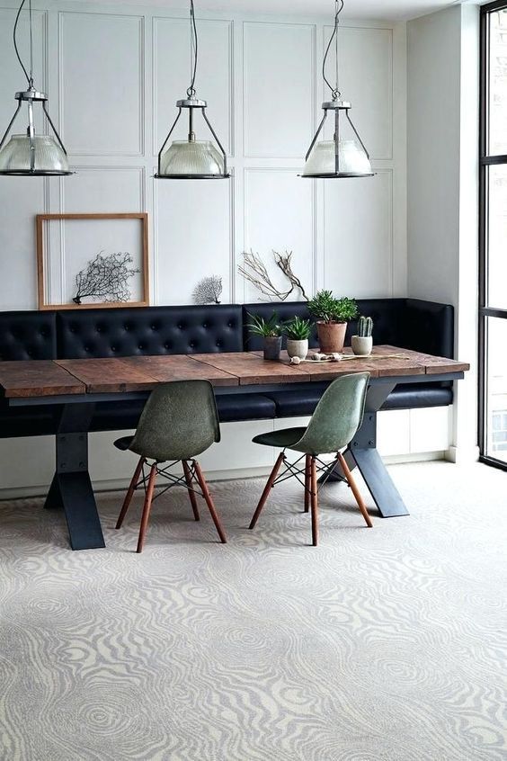 a dining room table with two chairs and a bench in front of the window,