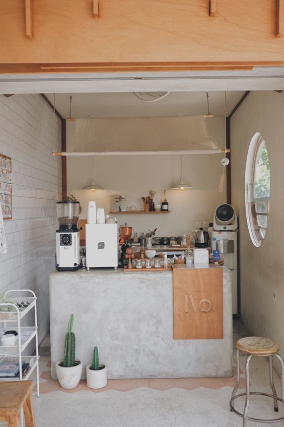 the inside of a coffee shop with cactus in pots and other items on the counter