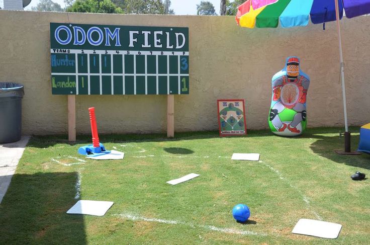 an inflatable ball sits on the grass next to a sign that says odddom field