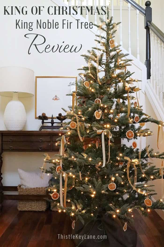 a christmas tree with gold ornaments on it and the words king of christmas king noble fire review