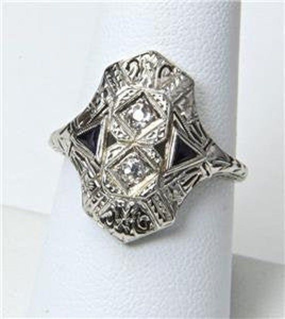 - Vintage 14k White Gold Art Deco Diamond Ring- Gorgeous details on face and shoulders- Ring size 8.25- Diamonds each measure 2mm in diameter- Ring face measures .8" tall by .72" wide and .24" deep- Wonderful vintage condition, signed / marked "BE"  "ML"- Weighs 4.2 gramsA wonderful antique ring! 14k Gold Art Deco Jewelry, Art Deco 14k Gold Promise Ring Jewelry, 14k Gold Art Deco Promise Ring Jewelry, 14k Gold Art Deco Promise Ring, Art Deco White Gold Jewelry With 17 Jewels, Heirloom Jewelry With Diamond Accents In 14k White Gold, Heirloom Jewelry In 14k White Gold With Diamond Accents, Art Deco White Gold Rings Stamped 14k, White Gold Art Deco Rings Stamped 14k