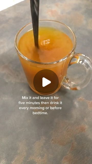 a glass cup filled with liquid on top of a table