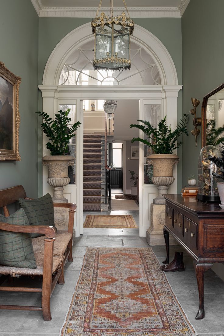 an image of a living room with green walls and white trim on the door way