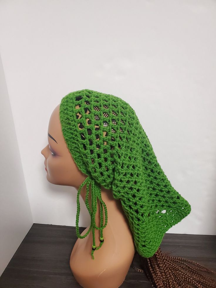 Forest Green Crochet Dreadlock Sleeve Tube Hat Add a touch of reggae to your style with this beautiful Forest Green Crochet Dreadlock Sleeve Tube Hat from HaT. Handmade with love, this hat features a mesh pattern and plastic beads accents, perfect for a casual occasion or travel. The drawstring and adjustable feature make it suitable for all head sizes, while the acrylic material and yarn fabric type ensure comfort and durability. Embrace the rastafarian theme with this stylish hat, suitable for Cheap Green Crochet Yarn Hat, Casual One Size Fits Most Cap Headwrap, Bohemian One Size Winter Headwrap, Casual One Size Fits Most Headwrap, Bohemian Winter Headwrap One Size, Bohemian One-size Winter Headwrap, Bohemian Beanie Headwrap, Casual One-size-fits-most Cap Headwrap, Adjustable Bohemian Winter Headwrap