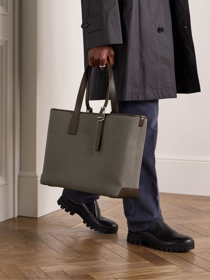 This tote bag is from the Dunhill’s '1893 Harness' collection, the buckled leather detailing pays homage to the brand’s saddlery heritage. Reinforced with leather trims, it's been woven in Italy and sized for your business essentials, like a laptop and notebook. The internal zipped pocket is ideal for tucking your phone and business cards. High-end Leather Handles Satchel Tote, High-end Leather-handled Tote Satchel, High-end Satchel With Leather Handles In Tote Style, High-end Satchel With Leather Handles Tote Shape, High-end Tote Satchel With Leather Handles, Luxury Shoulder Bag With Gunmetal Hardware And Double Handle, High-end Calf Leather Shoulder Bag For Work, Designer Coated Canvas Bags With Leather Lining, Designer Bags With Coated Canvas And Leather Lining