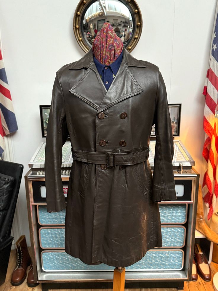 Top quality Vintage men's leather trenchcoat from the fabulous early 1970s. Made in Nottingham England by Philmar Clad tailored leatherwear. Nice dark brown colour,thick leather,fab wide highwaymans colour measuring near 5&1/4" inches,front panel consisting of 6 buttons,fab rear vent is an impressive 16" inches and overall the leather is in excellent condition,very light wear around the cuffs,shoulder seems as per normal and the odd scuff and scratch down the arms and below the pockets on bit si Vintage Long Leather Jacket For Business, Vintage Brown Leather Biker Outerwear, Nottingham England, Vintage Brown Retro Single-breasted Outerwear, Vintage Brown Single-button Outerwear, Retro Brown Single-breasted Leather Jacket, Vintage Single-breasted Leather Outerwear, Northern Soul, Belted Trench Coat