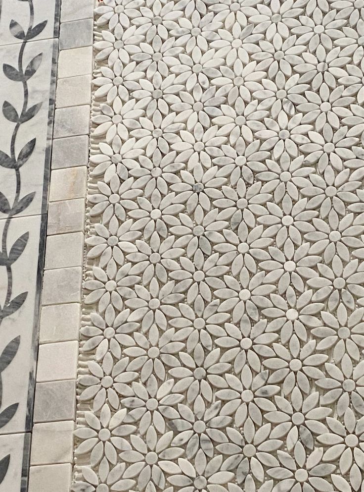 the tile is white and has black leaves on it