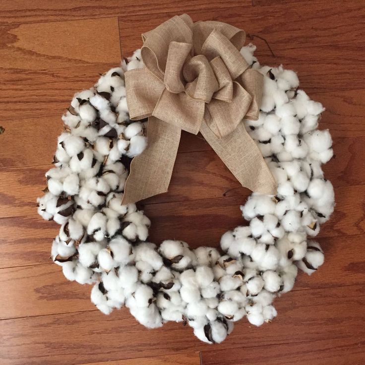 a wreath made out of cotton is sitting on the floor