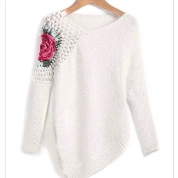 a white sweater with flowers on the side and a price tag for $ 377