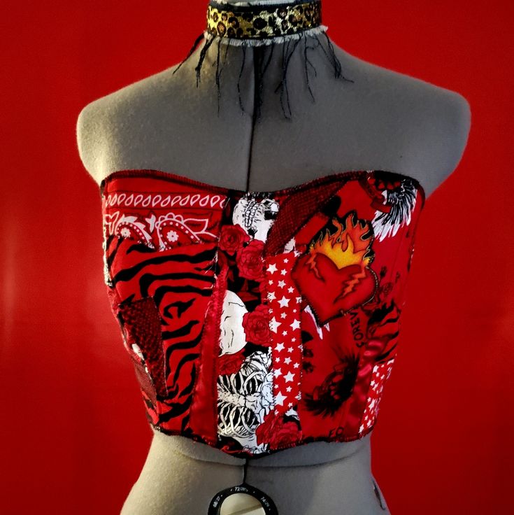 Hearts On Fire Patchwork Corset Top Cropped Corset Top Is Made From Scraps Of Different Red Fabric Including Zebra Print, Bandana, Tattoo Print, Snake Skin, Skull Rose, Etc. Stitched With A Raw Zigzag Stitch For A Grunge Look. Front Has A Broken Heart In Flames Patch. Overlocked Stiched Top And Bottom Hems. Lined With A Soft Red Snuggle Flannel Cotton. Lightweight With No Boning For Easy Wear And Care. Back Has Silver Grommets That Lace Up With Black Cording. Size Small. Hardcore Bombshell Cloth Red Y2k Style Tops For Party, Red Punk Fitted Corset, Red Fitted Punk Corset, Red Corset For Alternative Fashion, Fitted Red Summer Corset, Fitted Red Corset For Summer, Red Summer Corset, Fitted Red Corset For Festival, Red Punk Party Tops