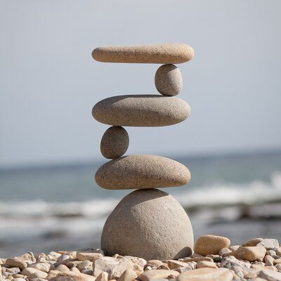 rocks stacked on top of each other in front of the ocean