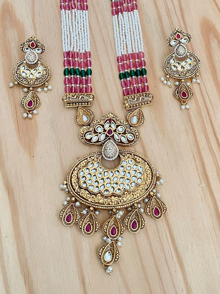 Elegant and sophisticated-looking Rajwadi Pendant Necklace with Kundan Stones Highlights of the necklace ** Rajwadi Finish Pendant, with Kundan Stones  ** Length of the necklace: 24 Inches with Dori in the back ** Length of the pendant 4 Inches (Please check the picture for the measurement) ** Dangle and Drop Lightweight Earrings. ** Length of the earrings: 2 Inches ** Long Pearl Mala Necklace ** Very Versatile, suitable for any occasion. ** Adjustable chain in the back ** Free shipping Pair this beauty with a Lehenga saree for any event. This will surely make your outfit look more sophisticated. I captured as many details as possible in my pictures and descriptions. If you have any other questions, feel free to contact us. Check out our other listings at: https://www.etsy.com/shop/mdbeadw Pink Jewelry For Diwali Puja, Festive Pink Jewelry For Puja, Pink Kundan Jewelry For Puja, Pink Kundan Necklace With Latkans As A Gift, Pink Kundan Necklace With Latkans For Gifts, Traditional Pink Kundan Necklace With Latkans, Pink Meenakari Temple Necklace Gift, Pink Jewelry For Puja Festivals, Pink Kundan Necklace With Latkans