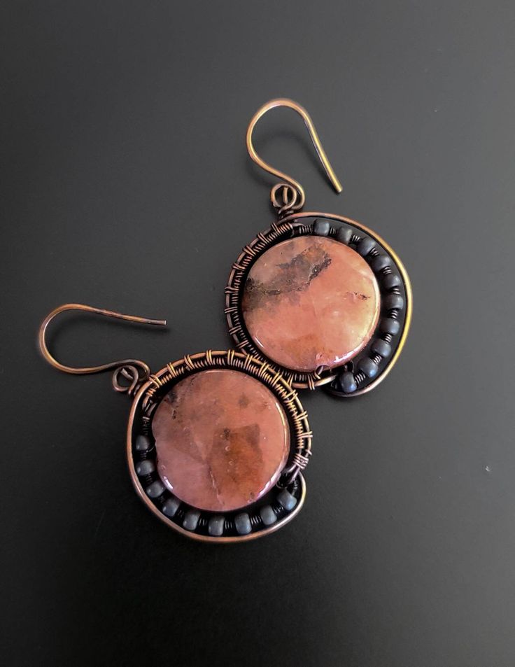 Hand dipped and polished copper wire wrap these beautiful organic looking cherry quartz stones. Japanese seed beads accent the side of each earring for an extra detail, as well as a little design on the back. Ear wires are hand forged using pure copper wire as well.  Please check out pictures for more details. The earrings measure almost 2" long. Artisan Handmade Earrings With Copper Wire, Artisan Copper Beaded Earrings As Gift, Artisan Handmade Copper Wire Earrings, Artisan Copper Beaded Earrings For Gift, Artisan Handmade Earrings In Copper Wire, Artisan Wire Wrapped Copper Earrings, Artisan Copper Wire Wrapped Earrings, Artisan Hand Wrapped Copper Earrings, Artisan Handmade Earrings