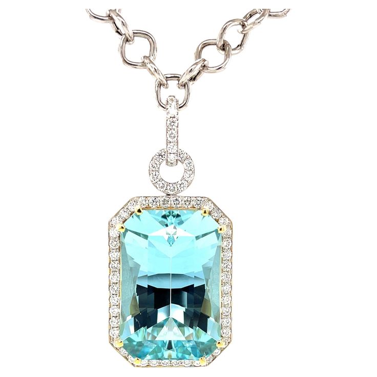 This stunning necklace features a magnificent 51.47 carat emerald-cut aquamarine with extraordinary blue color! The gem is surrounded by fine diamonds in an original pendant that is beautiful from every angle. The aquamarine is a perfectly proportioned "modified brilliant cut," with a rectangular outline and diamond-shaped facets that give this gemstone superior brilliance and life! We set this gorgeous blue gem in 18k yellow gold with double prongs and a custom designed 18k yellow gold basket. Diamond Enhancer, Gold Basket, Artisan Necklace, Gold Statement Necklace, Emerald Pendant, Elegant Pendant, Blue Gems, Modern Necklaces, Ring Pendant Necklace