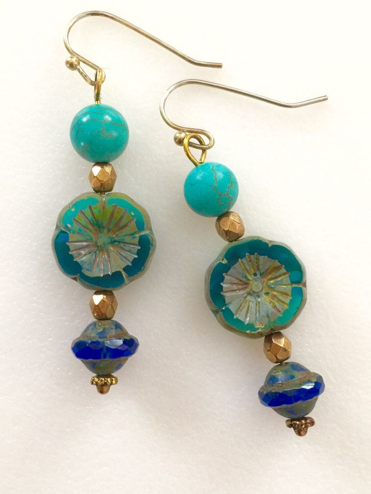 "Lightweight earrings handmade of semi-transparent aqua blue Czech glass Picasso flower, 8mm turquoise howlite, and cobalt blue Picasso UFO bead. Accented with light bronze Czech glass beads and gold wire. Earrings come on simple gold plated fish hook ear wires, lead and nickel free. Measure 2 1/8\"'long from top of ear wire." Blue Flower-shaped Jewelry With Spacer Beads, Turquoise Glass Earrings For Gift, Blue Round Beaded Earrings, Turquoise Czech Glass Beaded Earrings, Blue Round Beaded Earrings With Spacer Beads, Turquoise Glass Drop Earrings, Blue Adjustable Nickel-free Flower Earrings, Adjustable Nickel-free Blue Flower Earrings, Blue Round Beaded Earrings For Gift