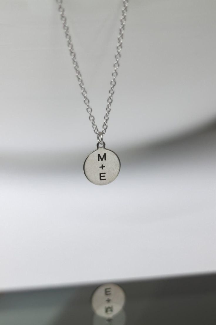 Initial necklace for men - chain necklace with a silver tone disc pendant with the engraving of your choice. Personalized necklace for men - engrave any word, letter or symbol. This necklace would make a great custom gift for birthday, anniversary or any occasion. Please write your engraving request at the 'Personalization' section before checkout.  Clasp closure.  Chain material: stainless steel (waterproof) Charms material: stainless steel (waterproof) Chain thickness: 2mm Pendant size: 1.5 cm Engraved Pendant Charm Necklace For Best Friend, Engraved Pendant Charm Necklaces For Best Friend, Engraved Silver Charm Necklace For Best Friend, Silver Hand Stamped Meaningful Charm Necklace, Minimalist Silver Dog Tag Charm Necklace, Laser Engraved Silver Jewelry For Anniversary Gift, Silver Laser Engraved Jewelry For Anniversary Gift, Silver Hand Stamped Necklace For Best Friend, Minimalist Stainless Steel Charm Necklace For Anniversary