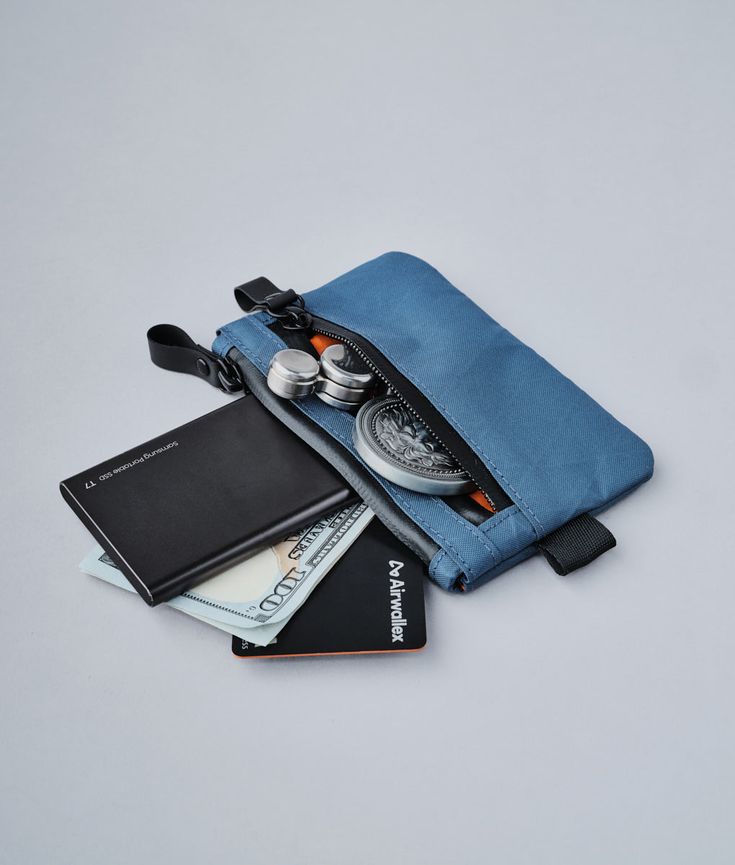 Stow your cards and cash quickly in our smallest pouch. Designed for those who want to carry as little weight as possible, the Zip Pouch has secure storage space for frequently used items such as credit cards and bank notes. With an extra pouch for coins or smaller items like your spare SIM card, you'll find room even for business cards too! Multifunctional Rectangular Tech Accessories For Daily Use, Functional Pouch With Zipper Pocket For Everyday, Functional Everyday Pouch With Zipper Pocket, Portable Functional Travel Accessories For Personal Use, Blue Travel Coin Purse, Blue Rectangular Pouch For Storage, Rectangular Travel Coin Purse With Pockets, Rectangular Coin Purse With Pockets For Travel, Functional Everyday Zipper Pouch