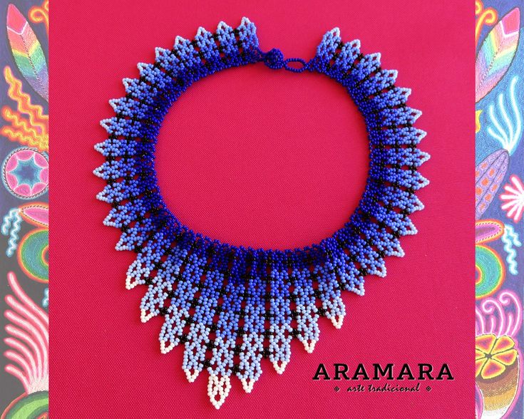 a blue and white beaded necklace on top of a pink card with the words aramara written below it