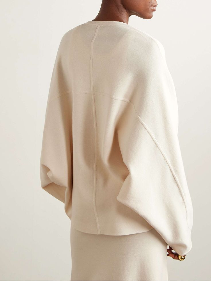 Oversized Elegant Cashmere Sweater, Elegant Wool Sweater For Loungewear, Elegant Oversized Sweater, Oversized Elegant Sweater, Modern Beige Sweater For Work, Modern Beige Sweater For Workwear, Modern Beige Workwear Sweater, Chic Beige Merino Wool Tops, Elegant Beige Outerwear With Ribbed Cuffs