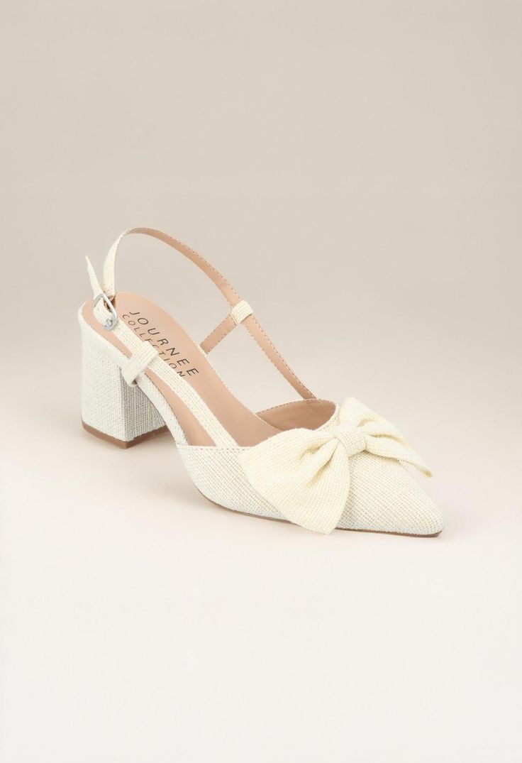 The Tailynn heel from Journee Collection exudes a timeless elegance with its pointed-toe design and a 2 1/2-inch block heel, offering both sophistication and comfort. The buckle detail adds a stylish touch while ensuring a secure fit, making these heels a versatile choice for various occasions. Crafted from fabric material and featuring a padded footbed, the Tailynn heel combines luxurious texture with practical comfort for a chic and elevated look. Block Heel Pumps, Journee Collection, Sling Back, Toe Designs, Heel Pumps, Pumps Heels, Fabric Material, Timeless Elegance, Block Heels